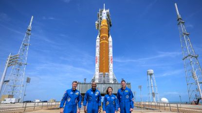 Artemis II astronauts stand before SLS rocket that will take them into space