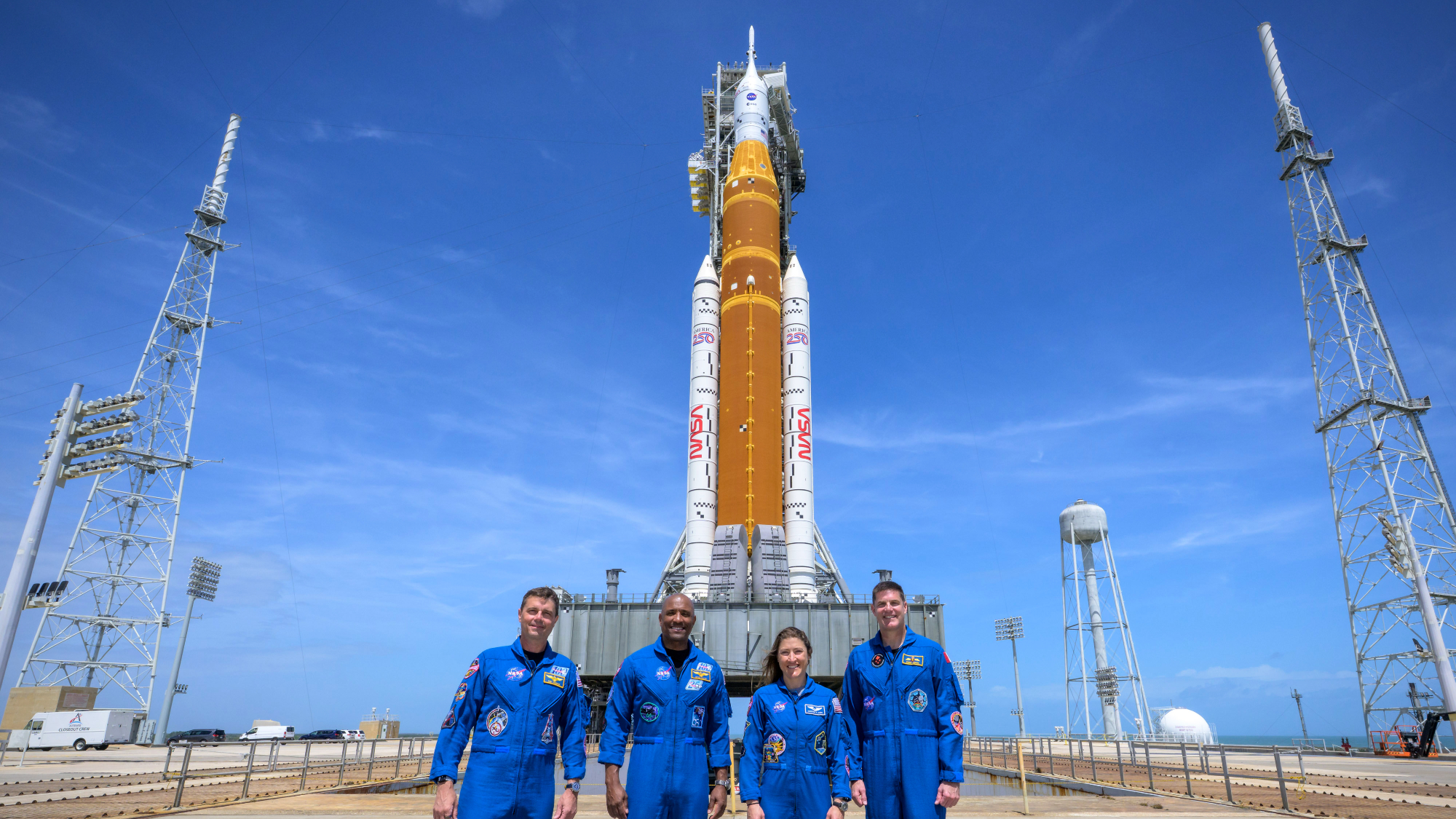 Artemis II astronauts stand before SLS rocket that will take them into space
