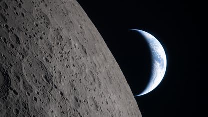 A view of Earth from the moon, with half the Earth illuminated and the gray surface of the moon in the foreground.