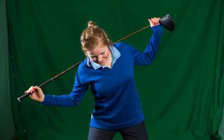 PGA pro Katie Rule demonstrating a handy drill to hone a good shoulder angle in your driver address position
