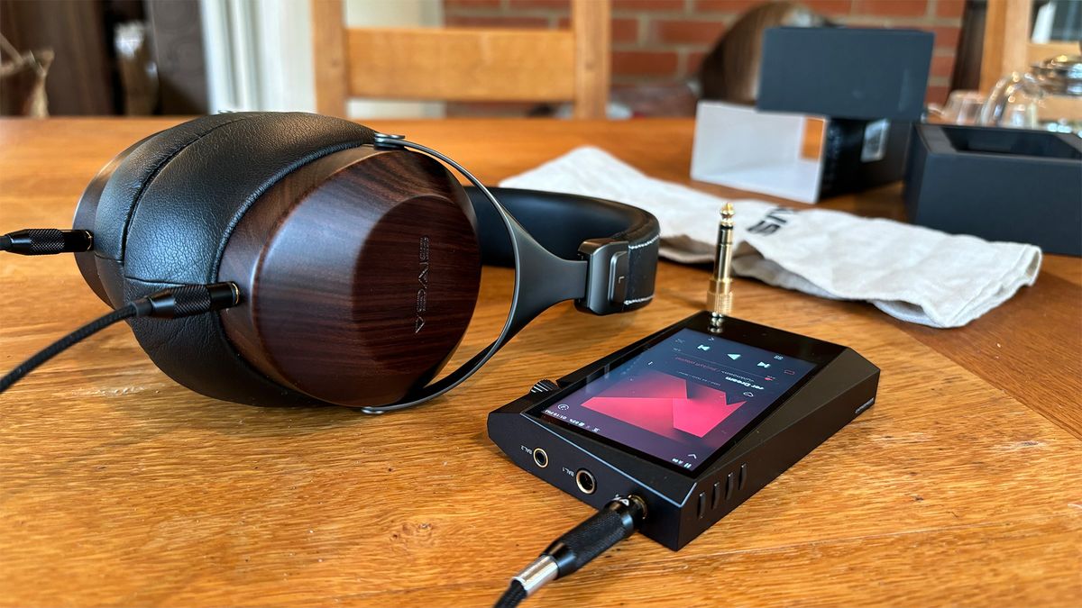 Sivga SV021 Robin over-ear headphones on wooden table next to Astell &amp; Kern music player