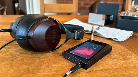 Sivga SV021 Robin over-ear headphones on wooden table next to Astell & Kern music player