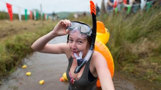 Elise Graham takes part in the World Bog Snorkelling Championships 2017 with a rubber duck on her back