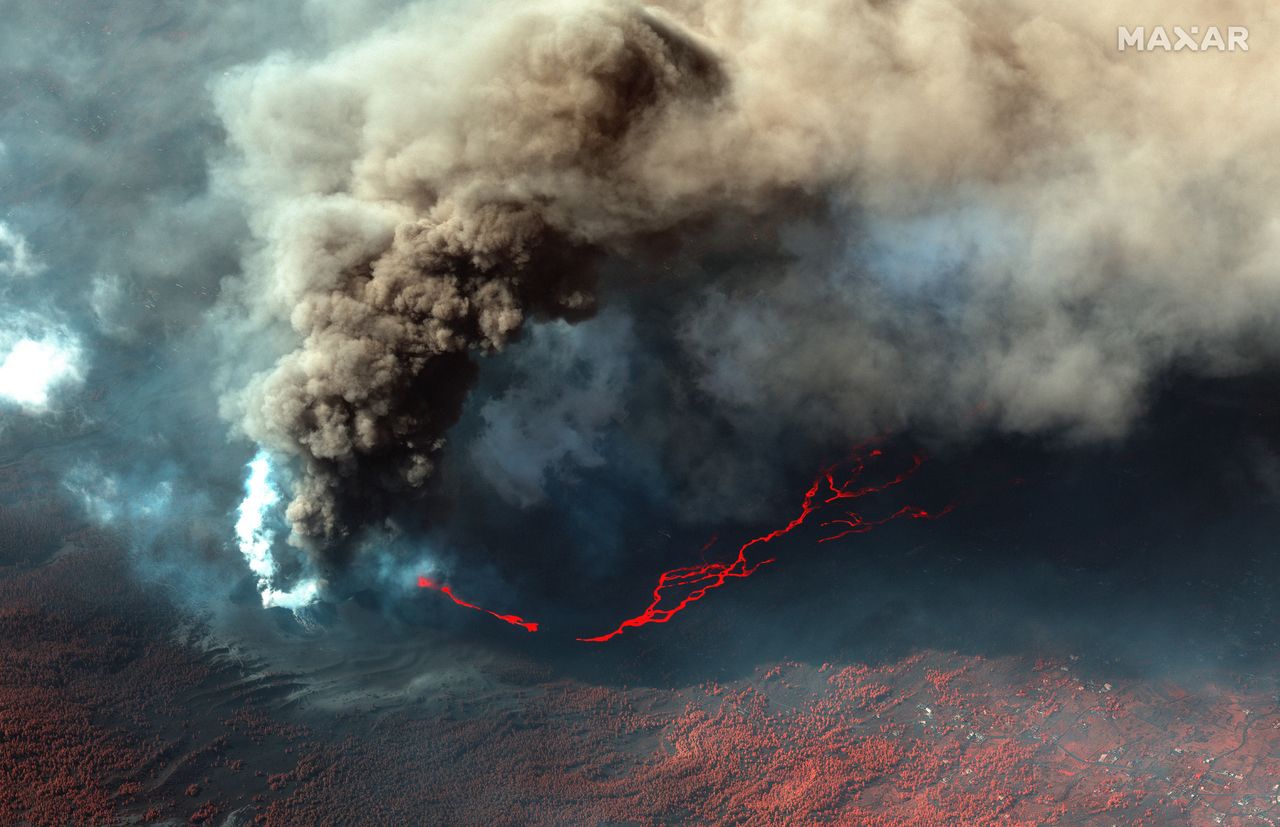 New photos of the Cumbre Vieja volcano on Spain's La Palma island taken on Oct. 14, 2021 show bright lava rivers from the continuing eruption.