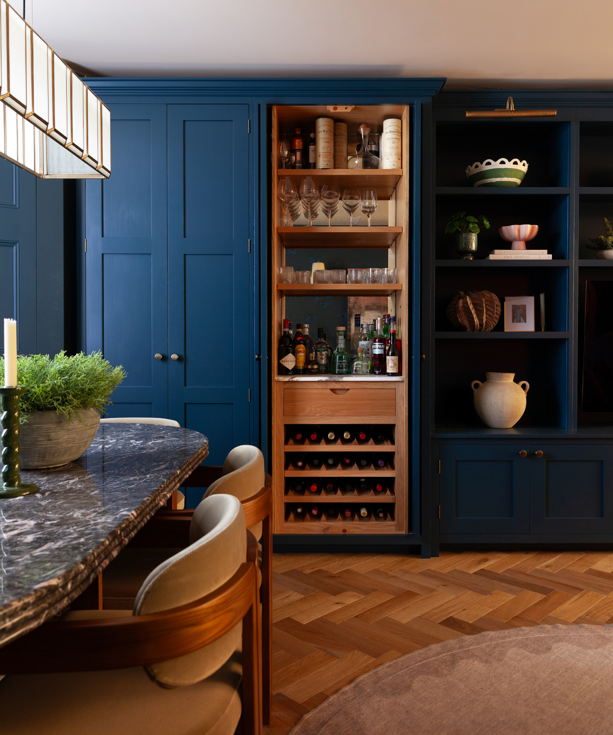 full height kitchen cabinets with pocket doors on one section open to reveal bar