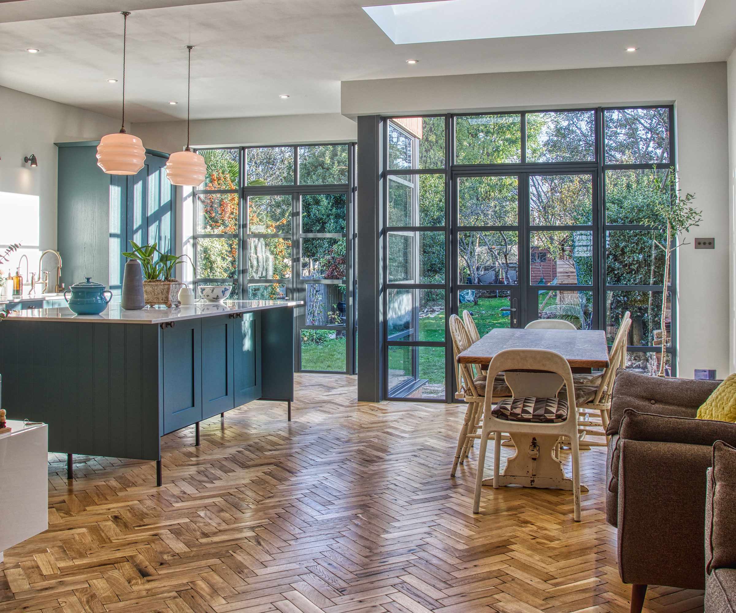heritage style Crittall French doors in kitchen extension with herringbone wooden flooring