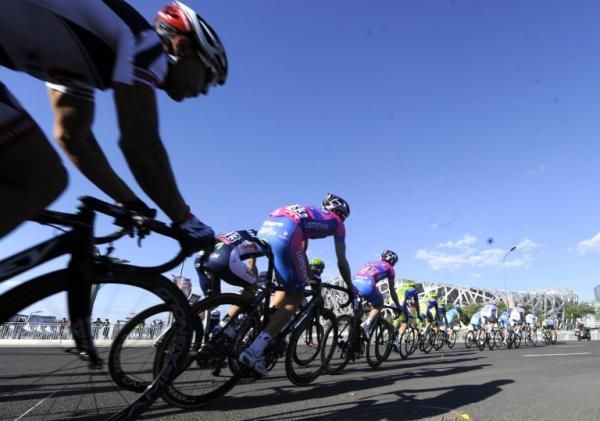 The Tour of Beijing peloton makes its way past the Bird's Nest Olympic Stadium during the opening stage.