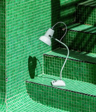 Green lamp against green tiled background