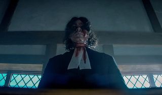 Michael Chandler stands at the pulpit with a bloody face in Fear Street: Part 3 - 1666.