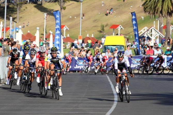 The riders snake across the width of the back straight