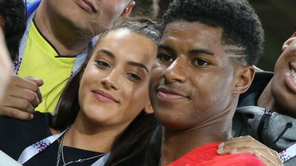 Marcus Rashford of England (R) and girlfriend Lucia Loi joins his family following the 2018 FIFA World Cup Russia Round of 16 match between Colombia and England at Spartak Stadium on July 3, 2018 in Moscow, Russia.