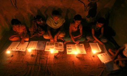 Muslim girls study by candlelight inside a religious school on the outskirts of New Delhi.