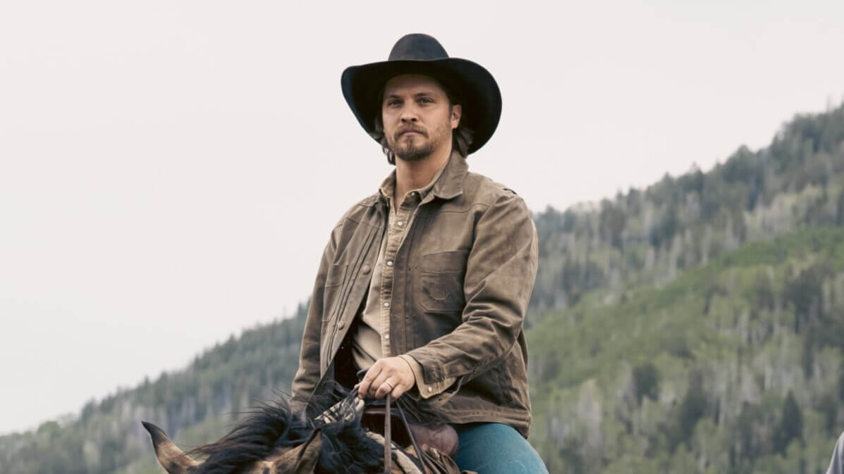 Luke Grimes as Kayce Dutton riding a horse in a promotional photo for 'Marshals'.
