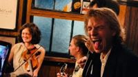 Mick Jagger with his tongue out in a pub