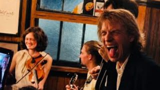 Mick Jagger with his tongue out in a pub