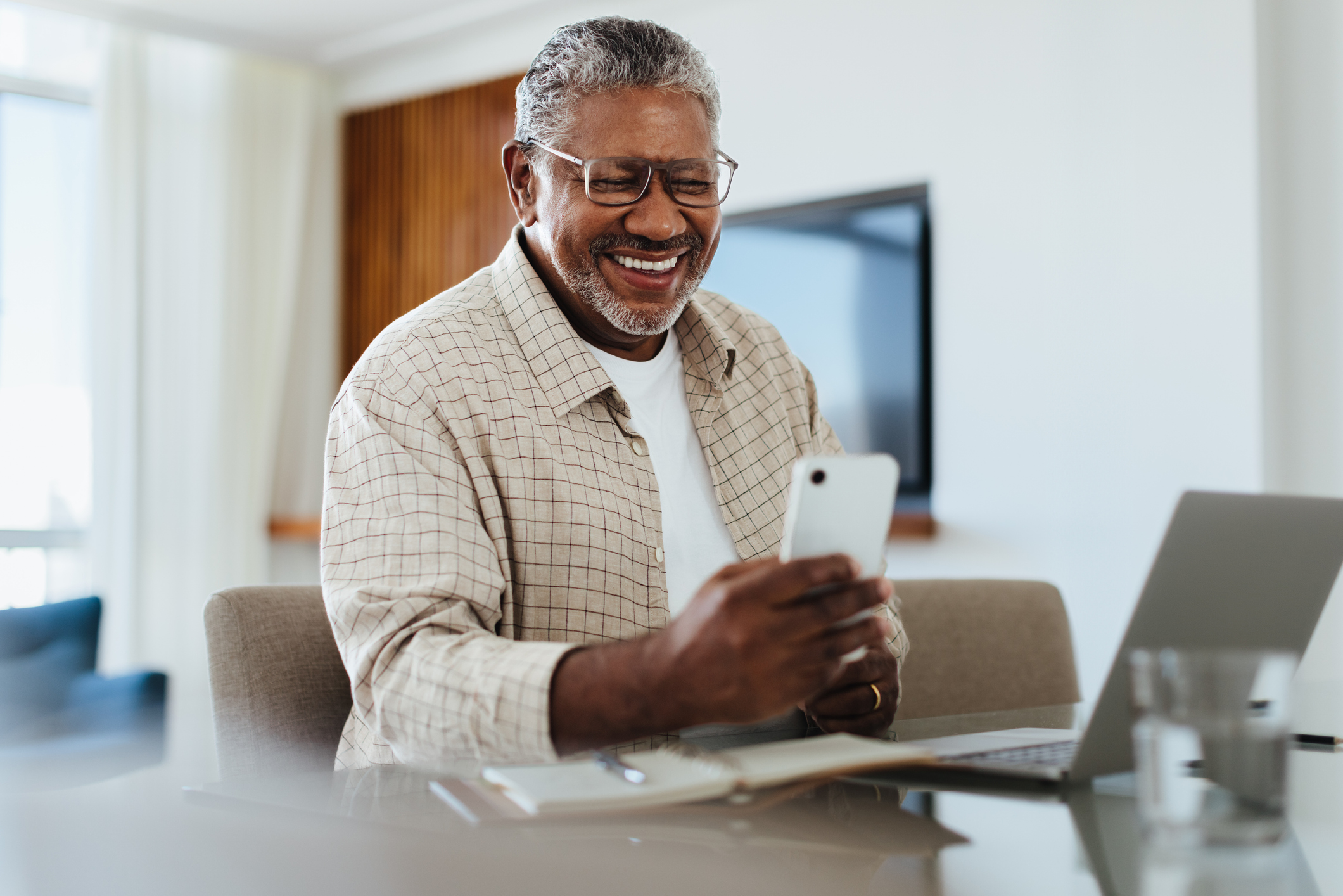 A man connecting with family on his cell phone.