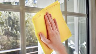 Wiping window with yellow cloth
