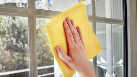 Cleaning window with yellow cloth