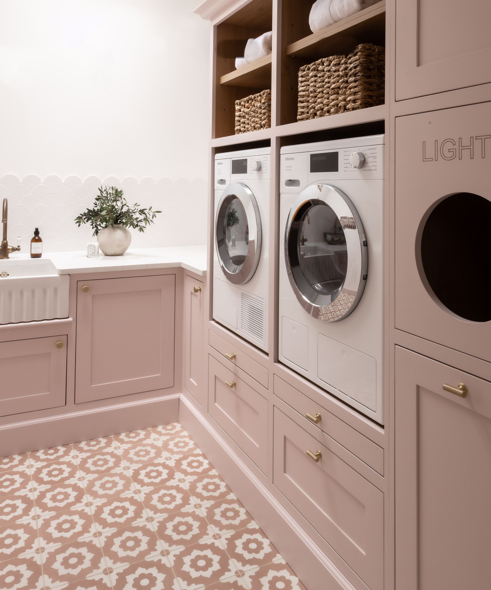 utility room with pink cabinets and pink geometric pattern floor tiles