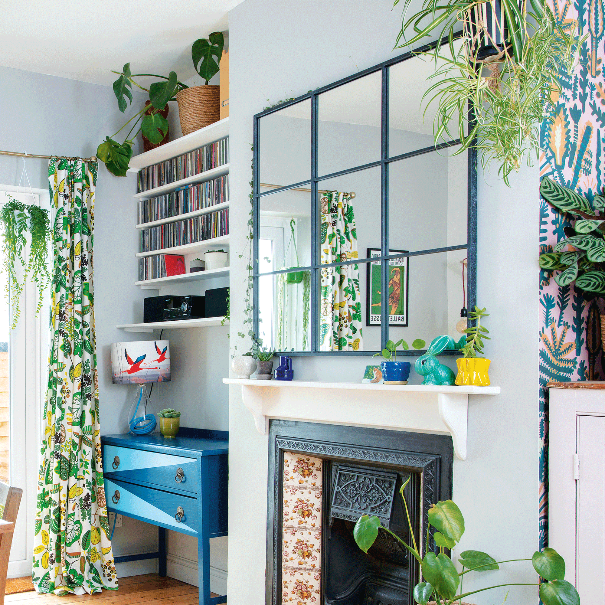 Blue living room with mirror and houseplants