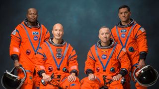The four male astronauts of NASA's Artemis 3 mission in a portrait wearing their orange spacesuits. They are: Andre Douglas, Luca Parmitano, Randy Bresnick and Frank Rubio.