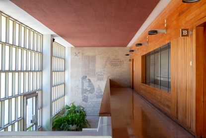 Interior of a building with a glass wall, wooden paneled wall and painted wall