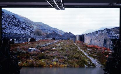 Screen showing dizzying highland vistas and mountain in the background