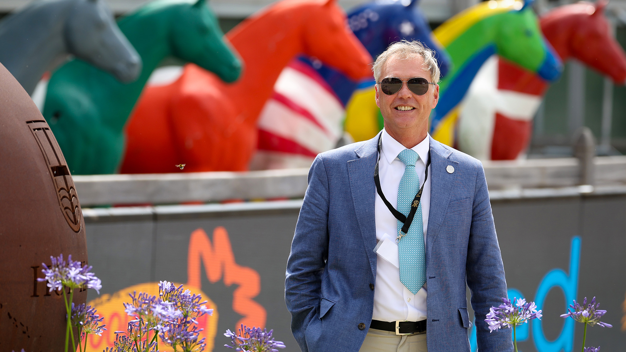 Clive Halsall at the Herning Dressage World Championships, with colourful model horses in the background