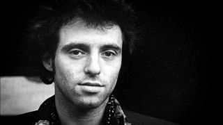 Nils Lofgren posing for a photograph in 1975