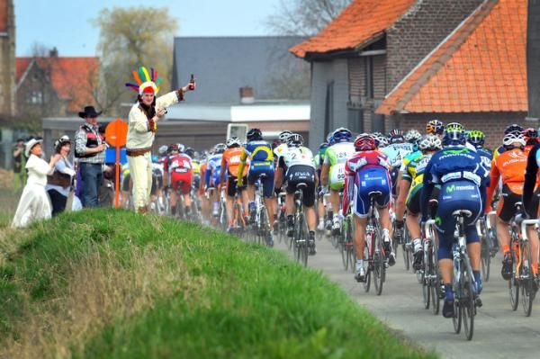 The Gent-Wevelgem peloton gets encouragement from some roadside spectators.