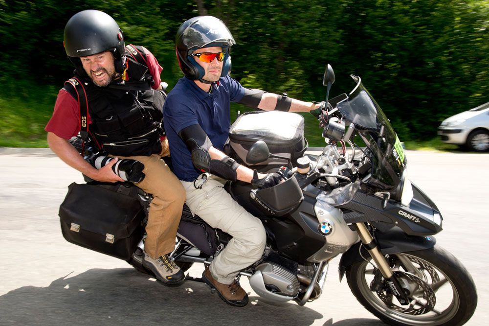 Doug Pensinger hamming it up on the back of a moto at the Tour de France
