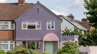 Purple house with green front door with pink arch