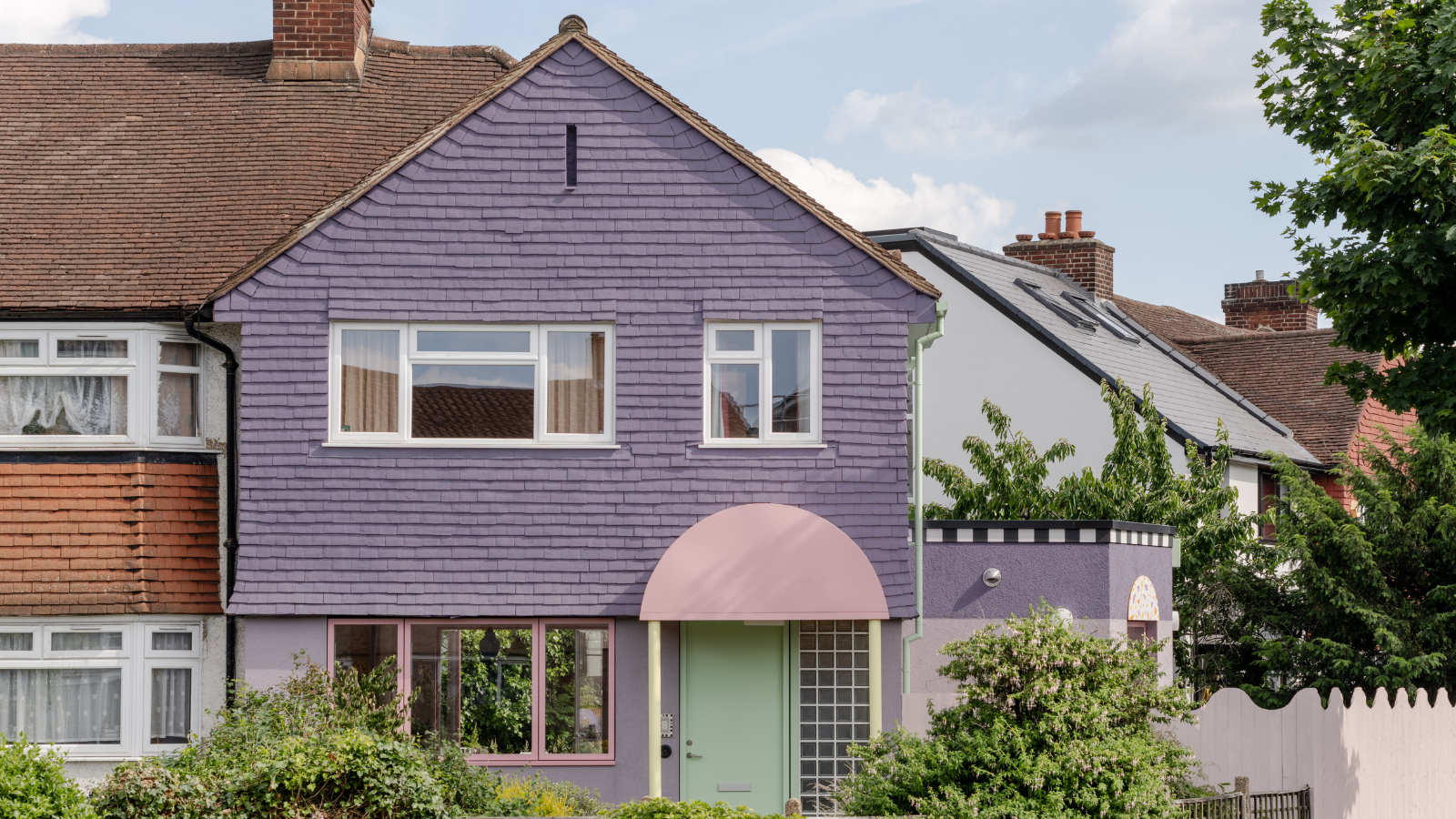 Purple house with green front door with pink arch