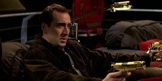 Nicolas Cage with golden guns in