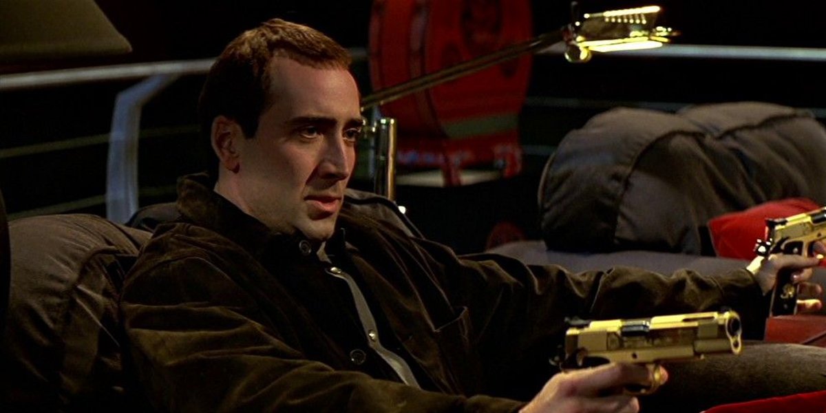 Nicolas Cage with golden guns in