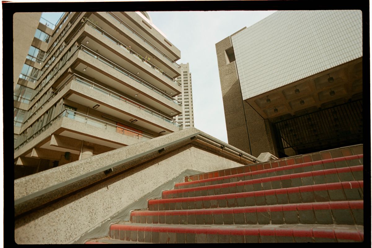 Scanned and digitized film image, using Valoi Easy 35 Pro V2 and Negative Lab Pro Lightroom plugin. Image shows several brutalist buildings and some brick steps