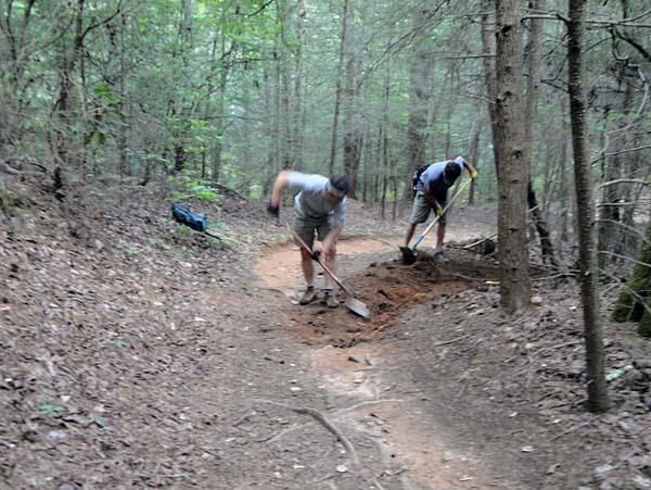 Two volunteers complete trail work.