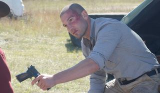 shane giving carl a gun on the walking dead tv show