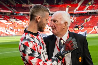 Former Manchester United goalkeeper Alex Stepney poses with David de Gea at Old Trafford to mark his 80th birthday at Old Trafford in October 2022.