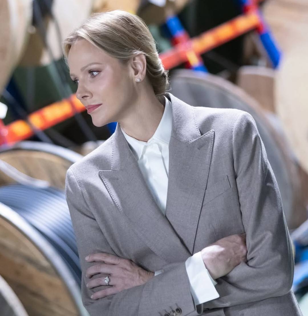 Princess Charlene wearing a blazer folding her arms
