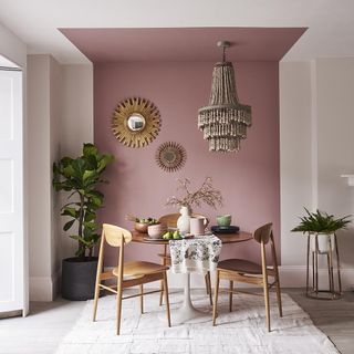 room with pink wall and wooden table