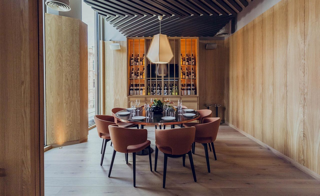 Private dining room in Issho restaurant, Leeds, UK with wood paneling on the wall and feature ceiling