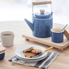 Blue tea pot and mug on a table 