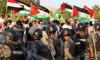 Palestinians wave flags during the commemoration Saturday of Israel's creation; the protest turned deadly after Israeli defense forces fired on demonstrators.