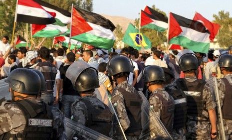 Palestinians wave flags during the commemoration Saturday of Israel&amp;#039;s creation; the protest turned deadly after Israeli defense forces fired on demonstrators.