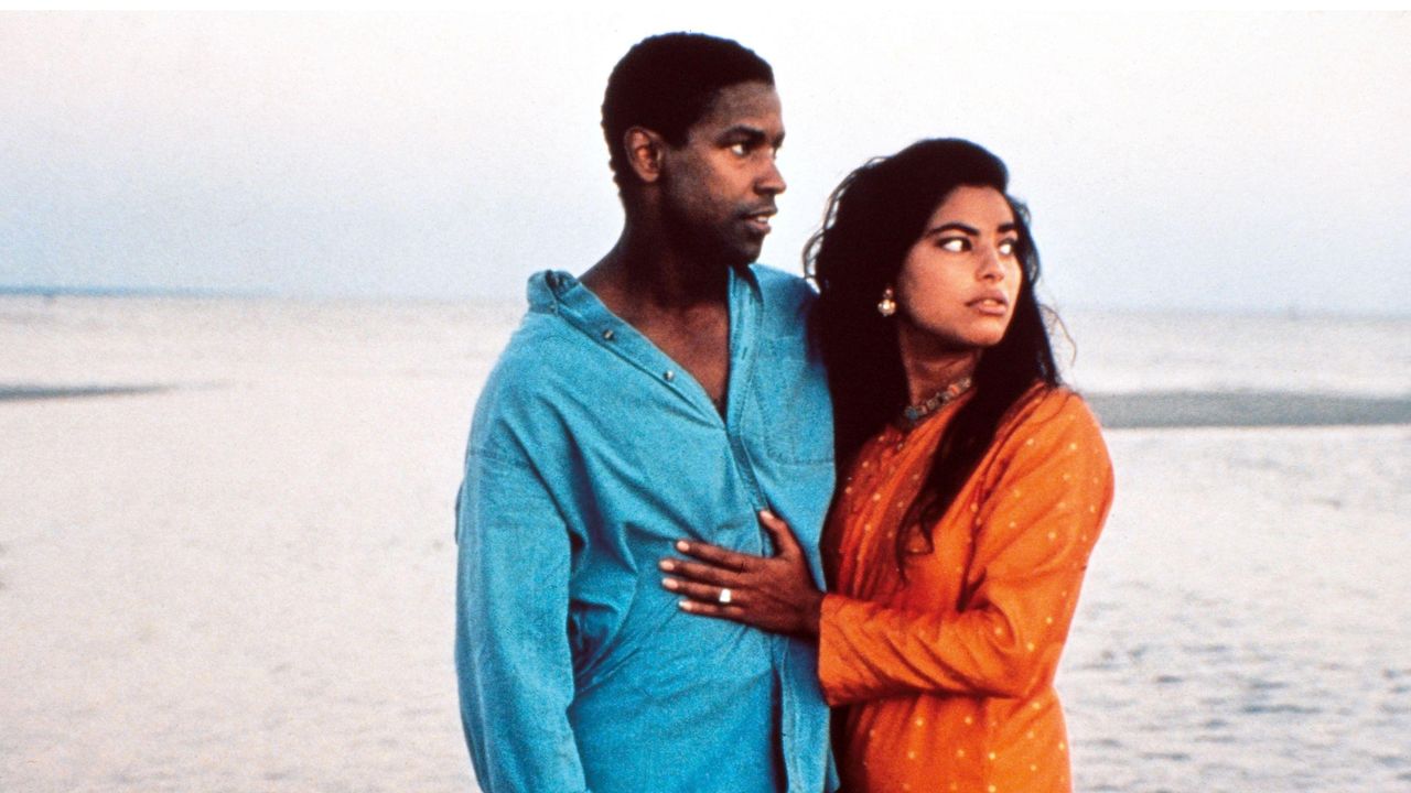 denzel washington and sarita choudhury embrace on a beach in mississippi masala