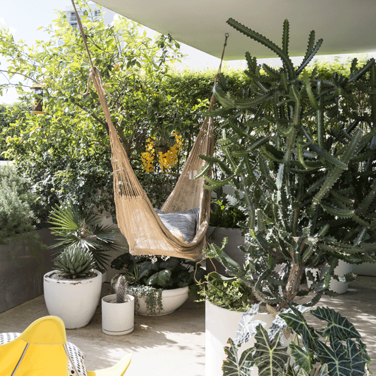 balcony with hammock and plant in pots
