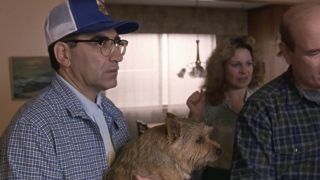 Gerry frowning while holding the dog in Best in Show