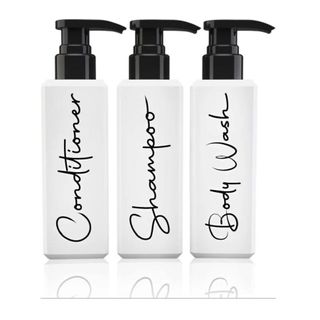 shampoo, conditioner and body wash pump botthes in white with black pump and black text