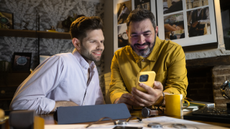 Two men looking at phone